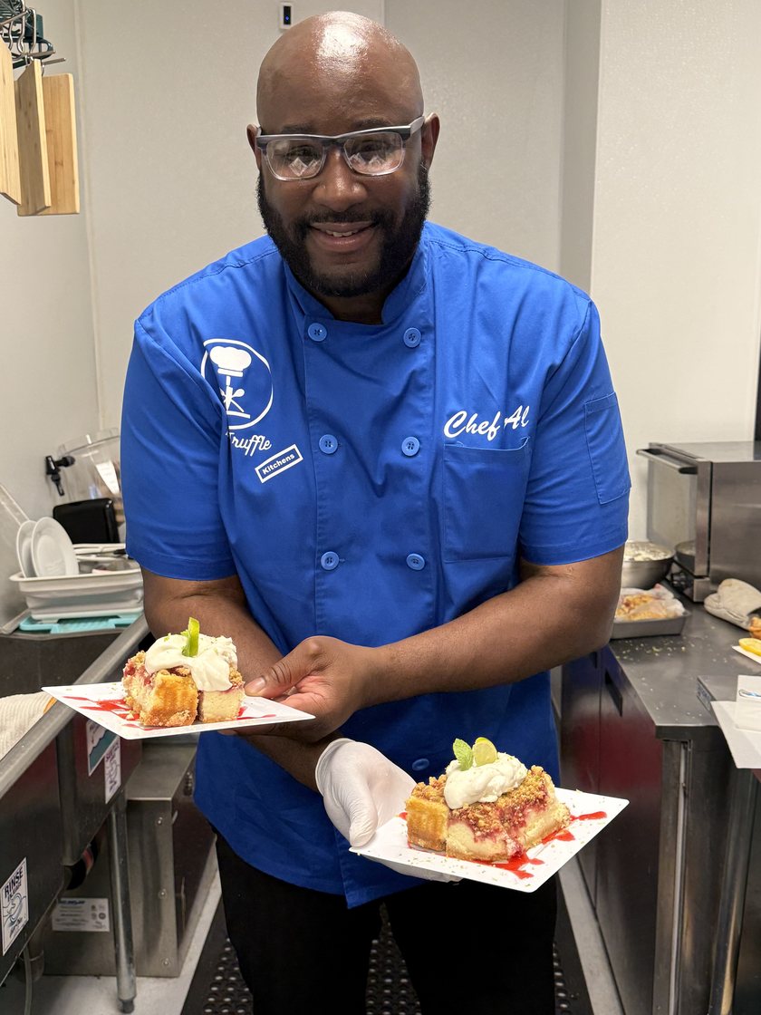 Chef Al in his kitchen, smiling at the camera.