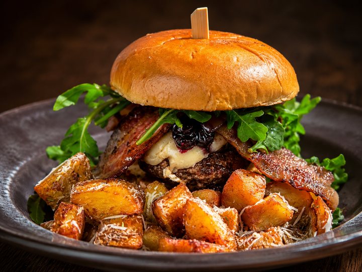The Bleuberry Royale Burger with brie, bacon, arugula and bleuberry pepper compote, served with rosemary truffled potatoes.